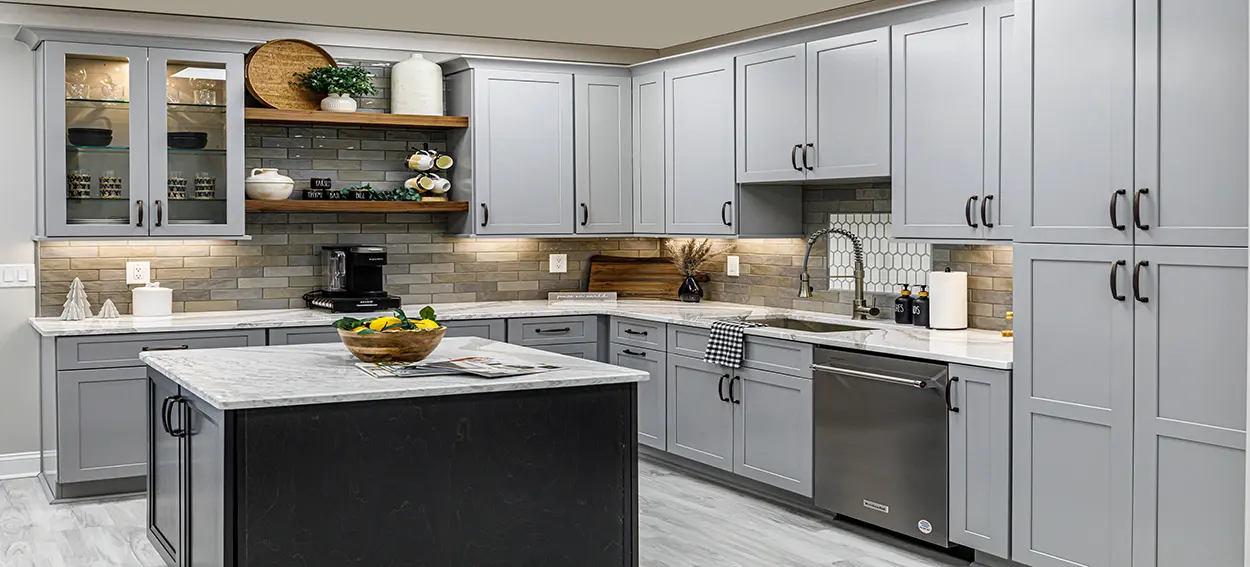 Remodeled kitchen featuring gray cabinetry, matte black hardware, and a custom tile backsplash.